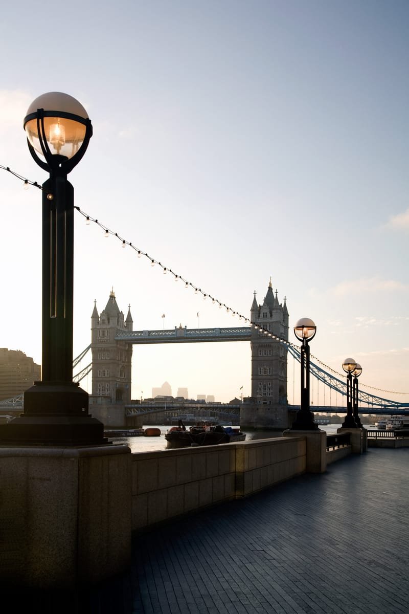 Ornate globe lamps on the riverside at sunrise, Tower Bridge behind
