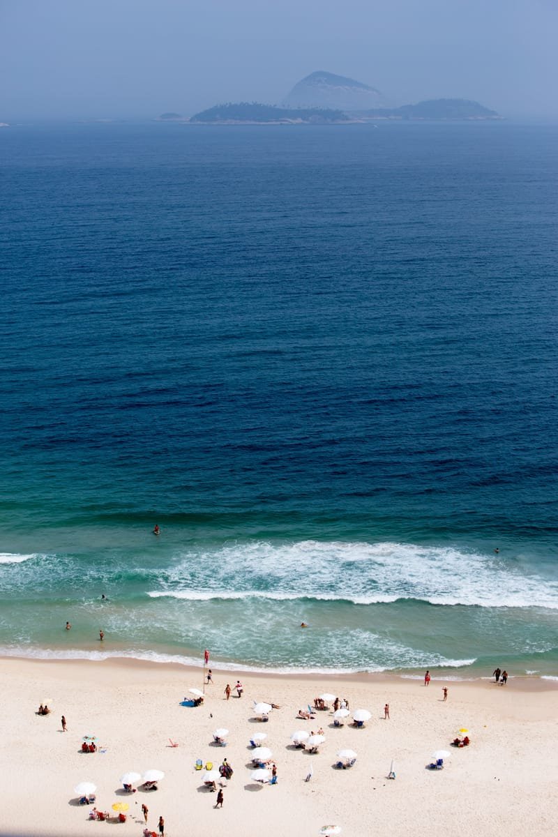 Ipanema Beach from above — bathers in the surf, deep blue sea, islands on the horizon, Rio de Janeiro