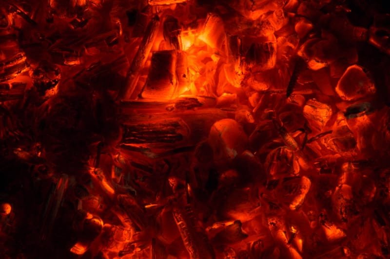 Close-up of glowing embers, red and gold