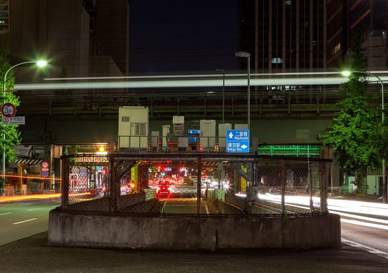 Light trails of traffic and an overhead rail line in central Tokyo at night