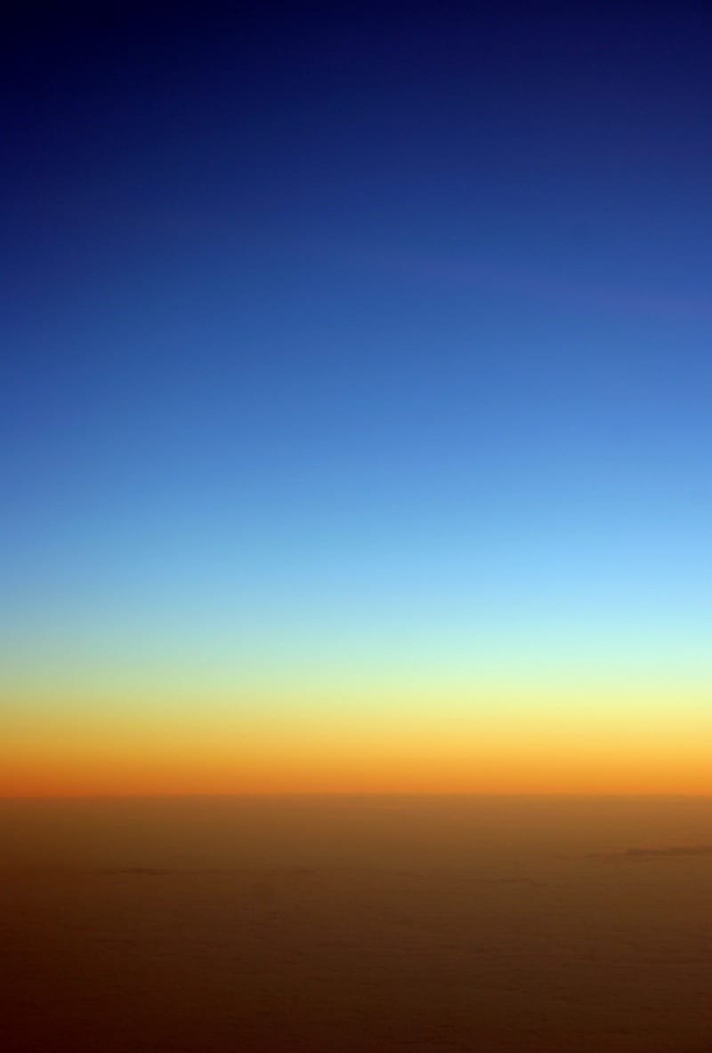 Deep blue dusk fading to amber over the Atlantic