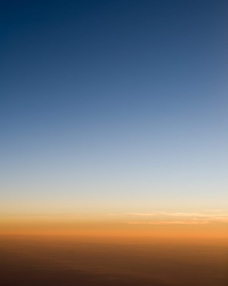A soft dawn gradient over a hazy horizon